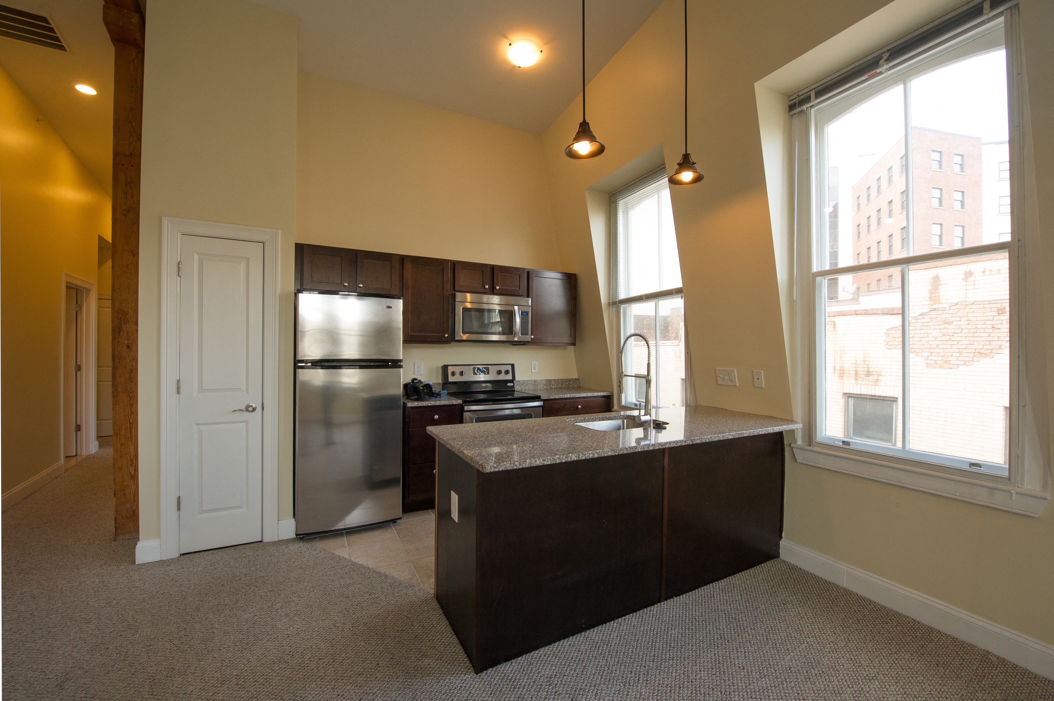a kitchen with stainless steel appliances and a large window